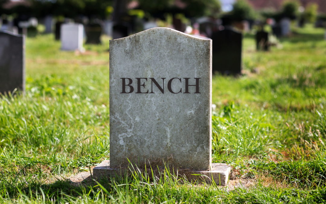 Image of a tombstone in a grassy cemetery engraved with the word 'BENCH,' symbolizing the closure or shutdown of Bench Accounting, a former accounting service provider.